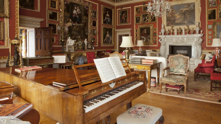 The Saloon at Hatchlands Park displaying the Cobbe Collection of pianos and paintings